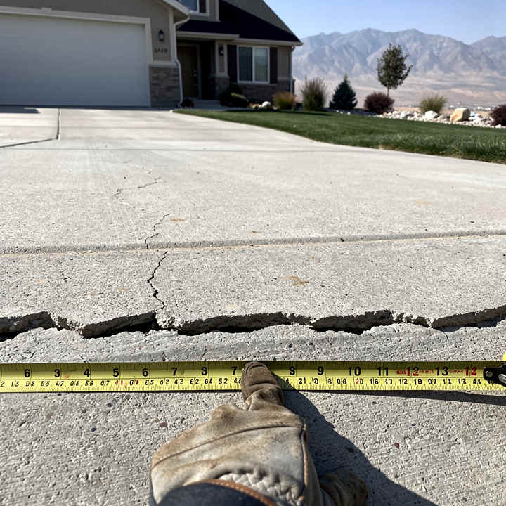 Cracked concrete driveway in Eagle Mountain UT needing repair before winter freeze